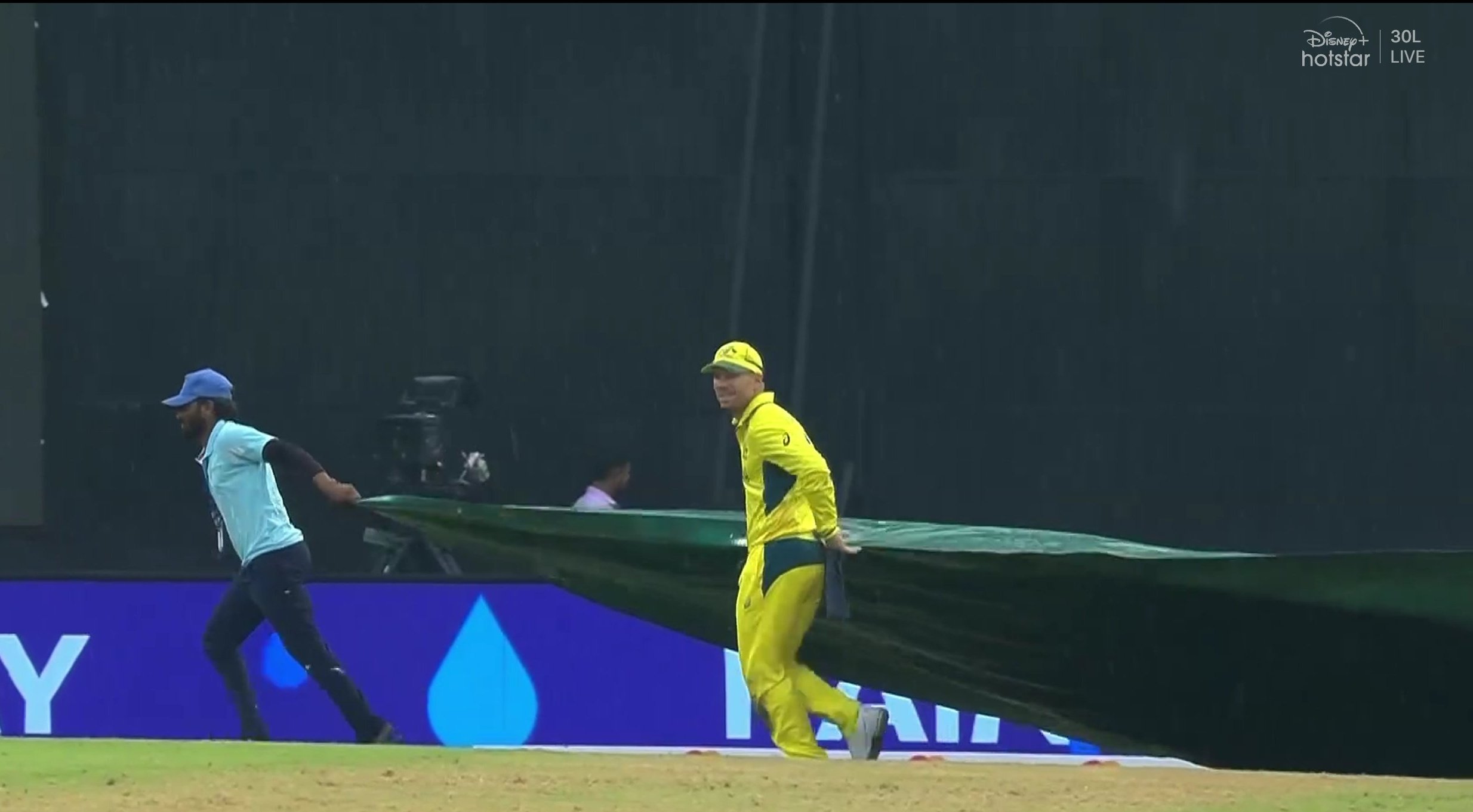 David Warner taking covers with ground staff.